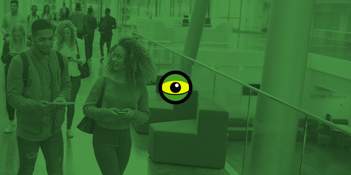 a group of students walking down a hallway with the green eye Security Monster logo