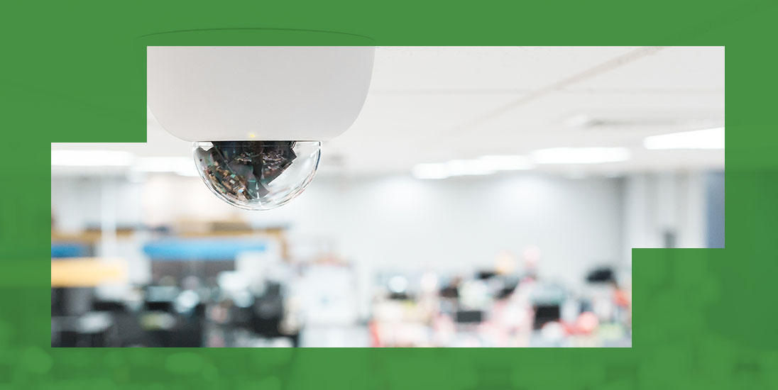 security camera hanging from the ceiling in an office building